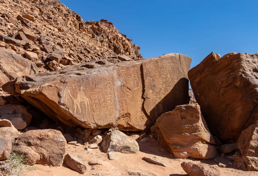 Inscribed sandstone boulders in the Wadi Rum desert landscape